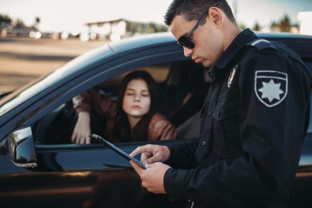 cop in uniform checks license of female driver 2021 08 26 16 26 43 utc 2